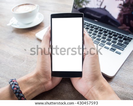 Close up of a man using smartphone with blank screen mobile and cup of coffee. 
