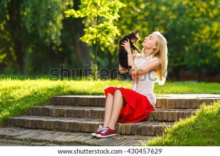 Dog and his owner - Cool puppy and young woman having fun in a park - Concepts of friendship,pets,togetherness