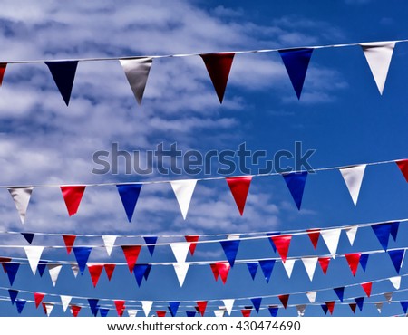 Celebration pennants against spring sky; colored bunting flying against spring or summer sky
