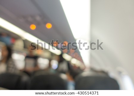 blur picture : Commercial aircraft cabin with rows of seats