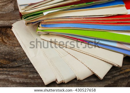 Newspapers and magazines on old wood background. 
