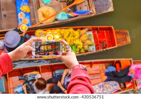 Smartphone photographing Damnoen Saduak floating market in Ratchaburi near Bangkok, Thailand Royalty-Free Stock Photo #430536751