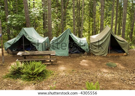 A group of canvas tents at a campground at the Camp Parsons boy scout camp in Washington. Some of the scouts' things like sleeping bags are just visible through the open tent flaps. Royalty-Free Stock Photo #4305556