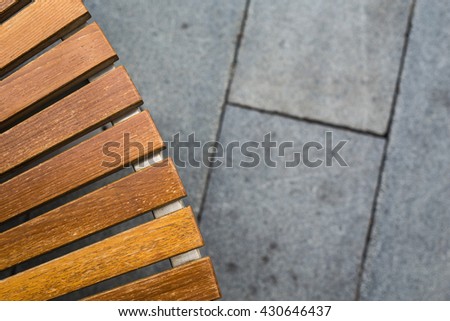 Art of abstract from shape,curve,line,shadow,light of asymmetrical pattern textured of wooden bench seat and floor with low key toned color and selective focus