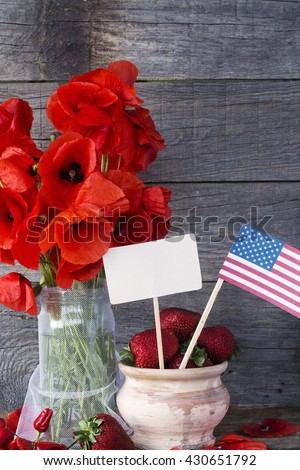 red poppies, US? flag. patriotic concept. soft focus omage