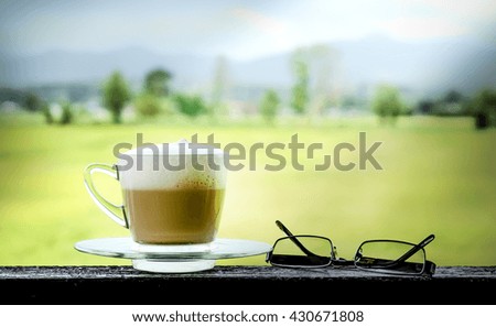 cup of cappuccino with glasses ,with blurred background,selective focus
