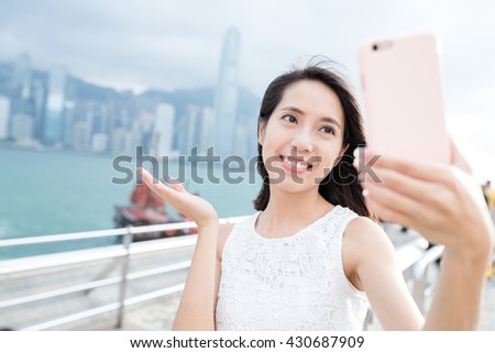 Woman taking picture by her self in Hong Kong