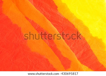 orange, red and yellow wrinkled torn paper - material sample - close up of textured background