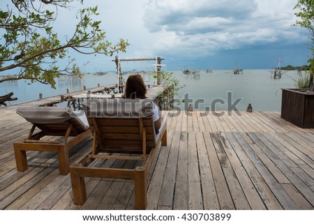 Young Asian traveler woman relax on the chair, Phatthalung, Thailand.