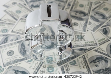 close up of dollar cash money and icon money bank on table. over light image, business, finance, investment, saving and corruption concept