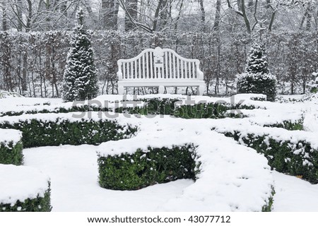 White vintage bench in park in winter