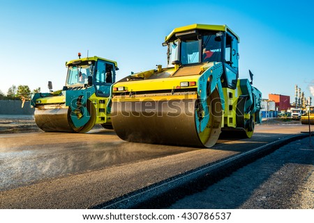 Large view on the road rollers working on the new road construction site Royalty-Free Stock Photo #430786537