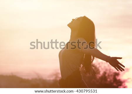 Young woman relaxing in summer sunset sky outdoor. People freedom style. Royalty-Free Stock Photo #430795531