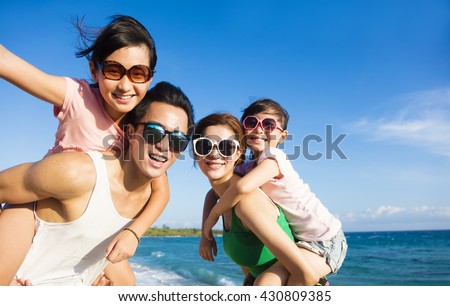 Happy Family Having Fun at the Beach Royalty-Free Stock Photo #430809385