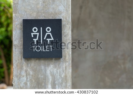 Unisex restroom or toilet sign on concrete wall style boutique .