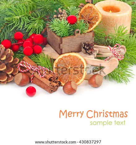 Wooden sledge, boxes with nuts and other Christmas decor on a white background. A Christmas background with space for the text.