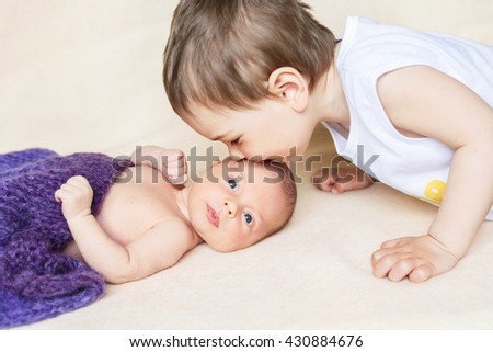 The boy kisses his newborn sister, girl, brother, kiss, love