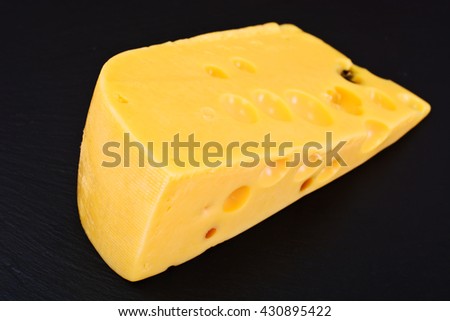 Swiss Cheese Isolated on Black Background Studio Photo