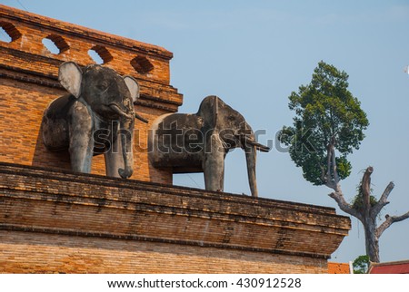 Sculpture of elephants on the stupa in a Buddhist temple. Chiangmai. Thailand
