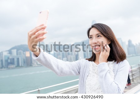 Woman taking selfie in Hong Kong city
