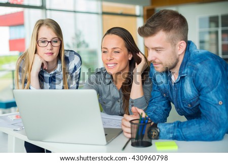 Photo of young freelance designers working in office