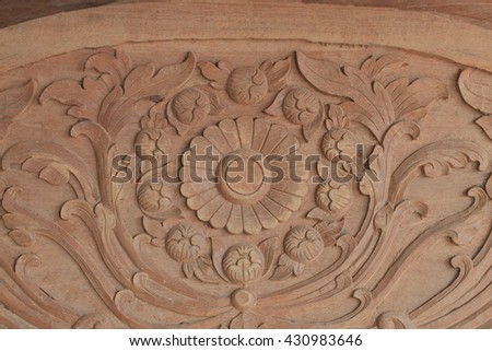 Pattern of flower carved on brown wood background
