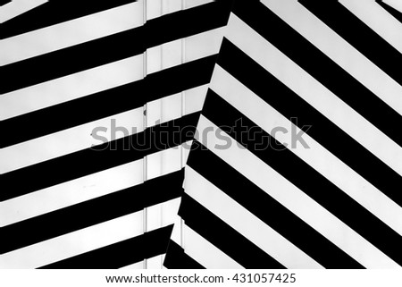 Abstract white and black-colored background. Which uses parallel lines, creating a mesmerizing effect. 