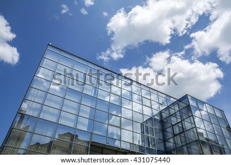 Building facade with blue sky and white clouds Royalty-Free Stock Photo #431075440