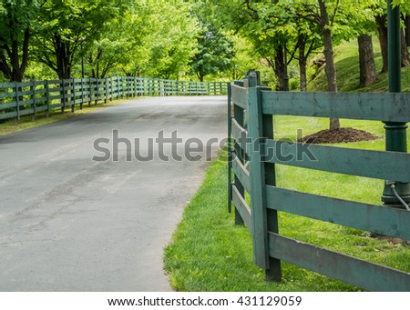 Green Fence Lining the Road to a Kentucky distillery Royalty-Free Stock Photo #431129059