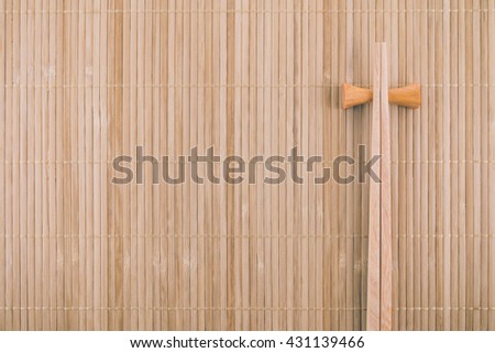Flat lay Japanese mat background with two sushi chopsticks
