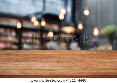 Top wooden table with cafe background, stock photo