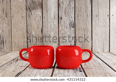two red cup on wood table