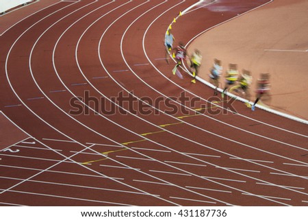 Athletes in motion on professional track and field race. Nice picture for olympic game in Rio