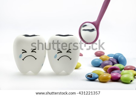 Tooth decay is crying with dental mirror and sugar coated chocolate on the side. On a white background