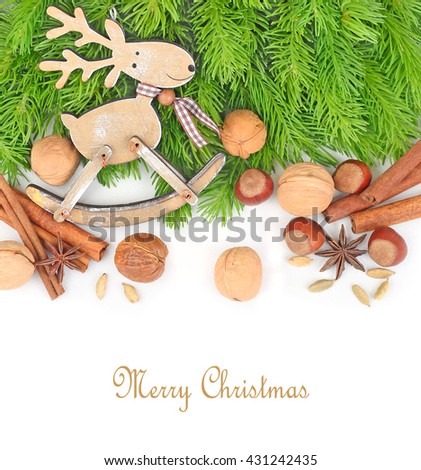 Wooden deer and nuts on branches of a Christmas tree on a white background. A Christmas background with space for the text.