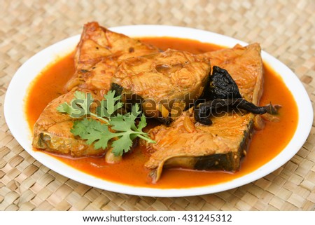 Hot and spicy popular Kerala fish curry, King fish curry prepared using Indian spices and gambooge . South Indian dish. Indian food. rice and fish