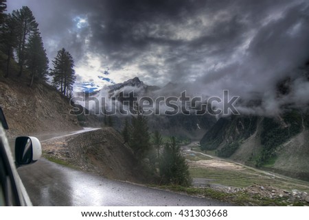 storm clouds over mountains of ladakh, Leh Srinagar Highway, green valley sccenary, Jammu and Kashmir, India. Rainy weather , stock image.