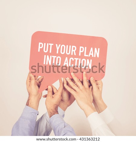 A group of people holding the Put Your Plan Into Action written speech bubble