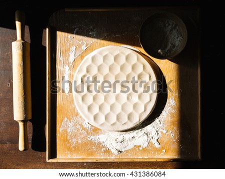 Step by step process of making home-made dumplings or pelmeni with minced meat filling using ravioli mold or maker. Top view  in mold on old table