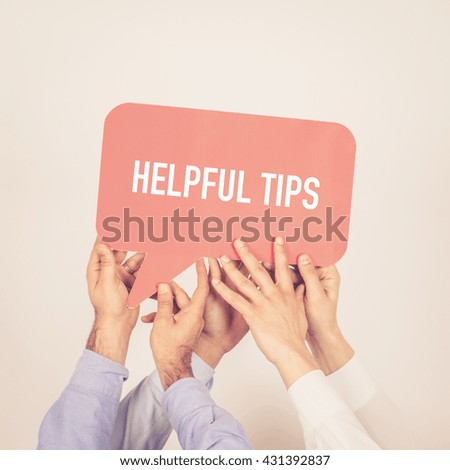 A group of people holding the Helpful Tips written speech bubble