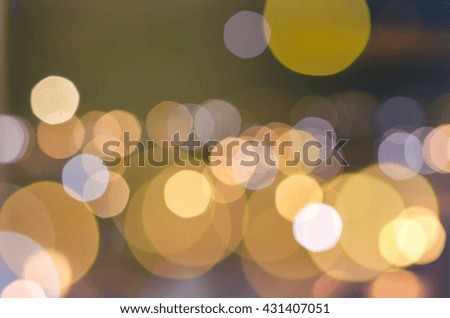blurred light in warm tone background:blur of night market shopping concept:out of focus concept.blurry Christmas golden bubble light wallpaper.orange glitter shine golden bronze display picture