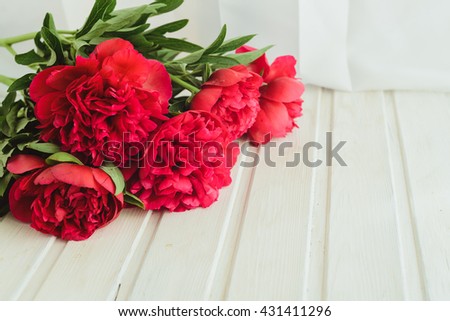spring-summer concept, a red peony bouquet on a white background with copyspace