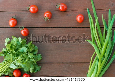 Group of fresh vegetables on the wooden background top view. Available space at center
side.