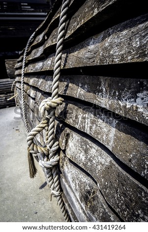 Rope knot and with wood background old texture of wooden boards with ship rope