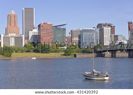 Portland Oregon skyline and a sailboat in morning light.