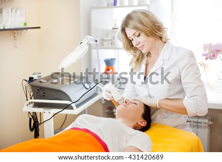 woman passes cosmetic procedures in the office cosmetologist aesthetists Royalty-Free Stock Photo #431420689