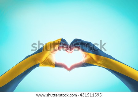 Sweden flag on people heart   shape hands.