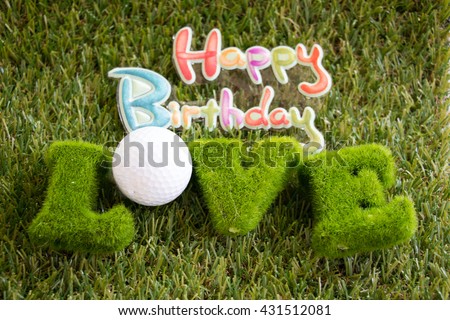 Happy Birthday sign and love letter with golf ball on green golf course idea for birth day card for golfer
