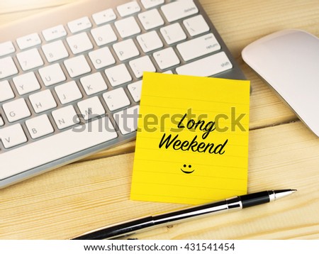 Long weekend on sticky note on work desk Royalty-Free Stock Photo #431541454
