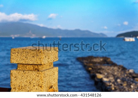 old stone Pier and blue sea.